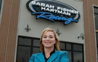 Sarah Fisher standing outside the SFHR headquarters.