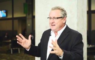 A picture of Mark Schaefer talking with his hands.