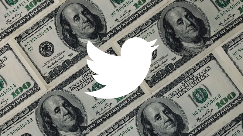 The Twitter logo in front of money
