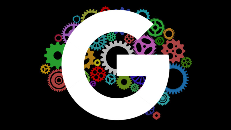 The Google logo in front of a set of cogs