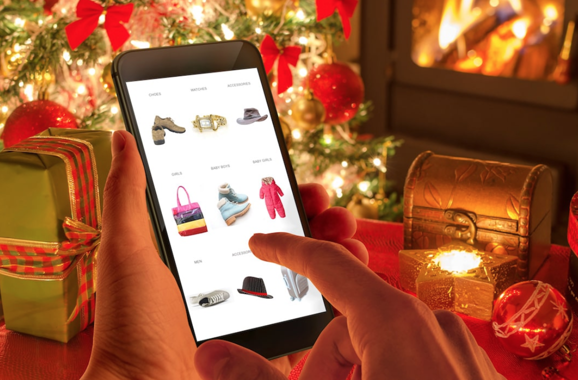 A christmas setting showing a phone on a shopping app