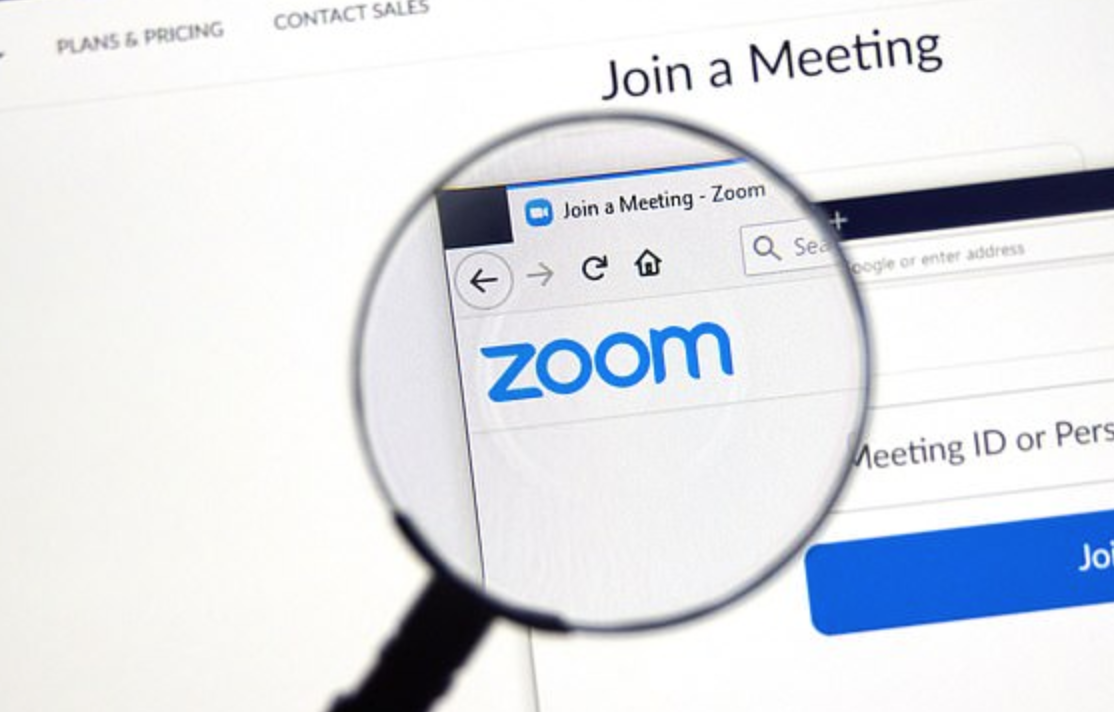 A magnifying glass over the Zoom logo
